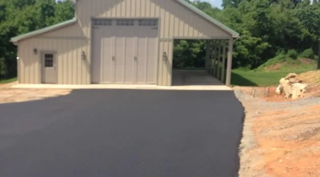 Newly paved residential driveway leading to an attached garage