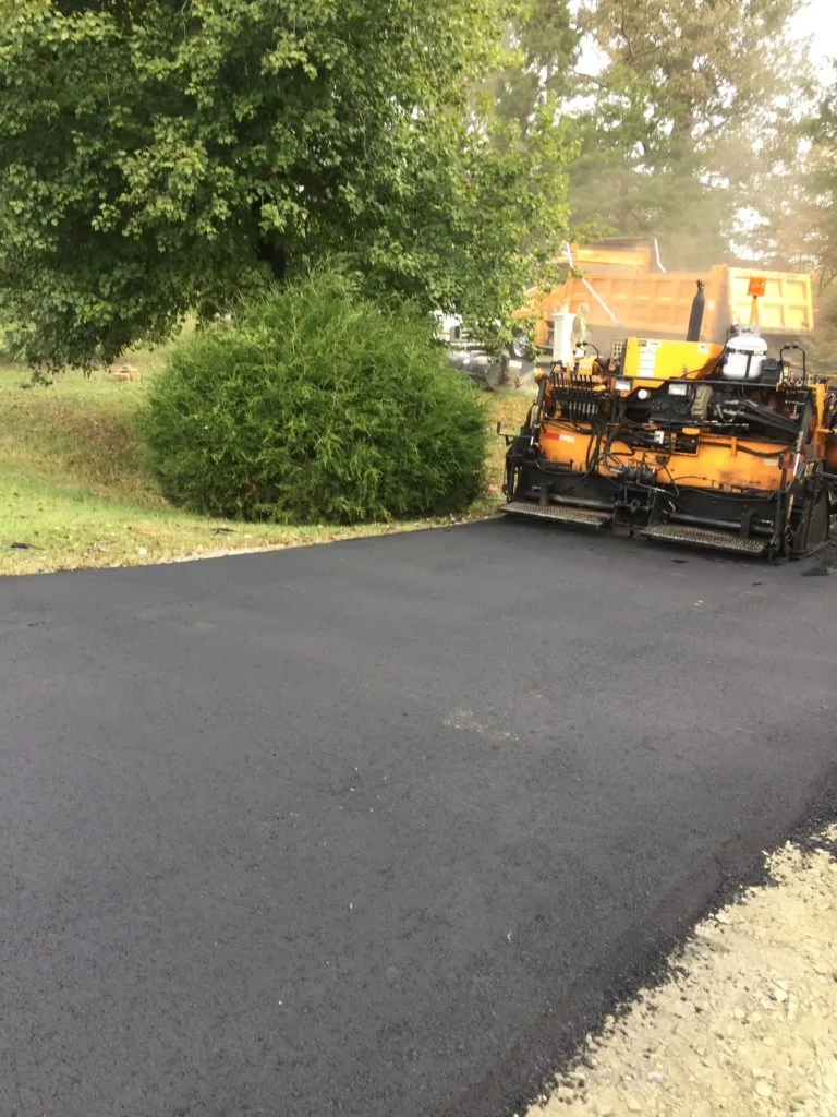 Paving crew finishing a smooth new asphalt surface