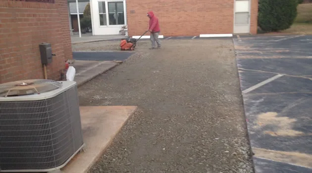 Newly compacted asphalt drive with a uniform black finish