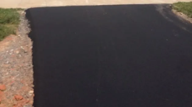 Fresh asphalt surface with a clean edge against the curb line