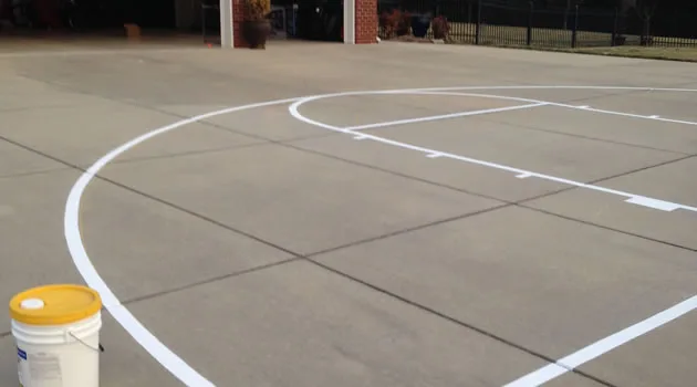 Regulation basketball court markings on a smooth asphalt surface