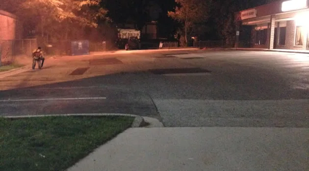 Patched and restriped parking stalls with a safety cone