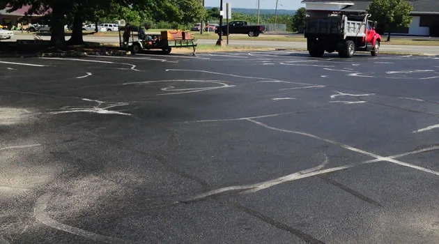 Safety cone on a freshly sealcoated and restored lot