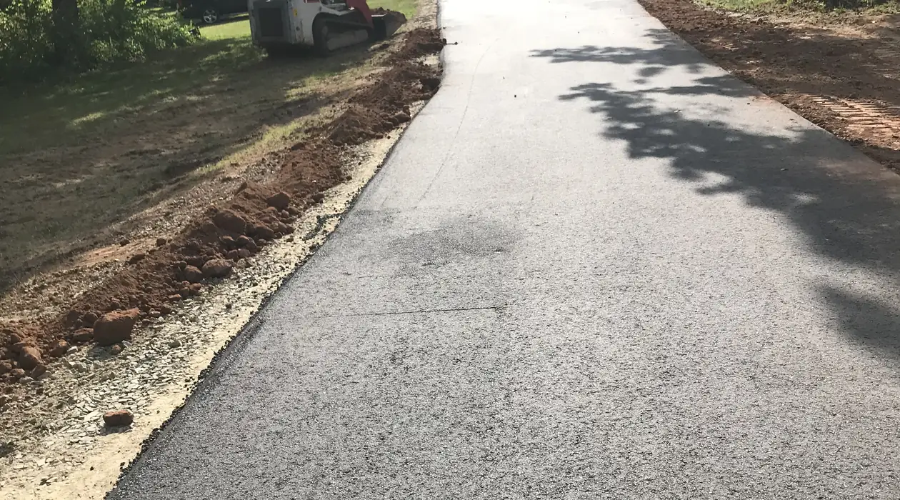 Newly paved drive with the base graded and edges dressed