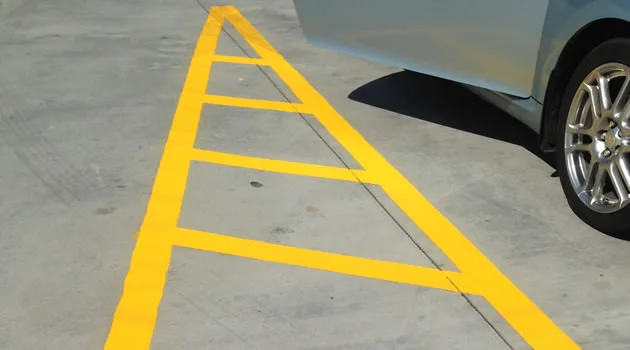 Striping crew applying line work with a walk-behind striper